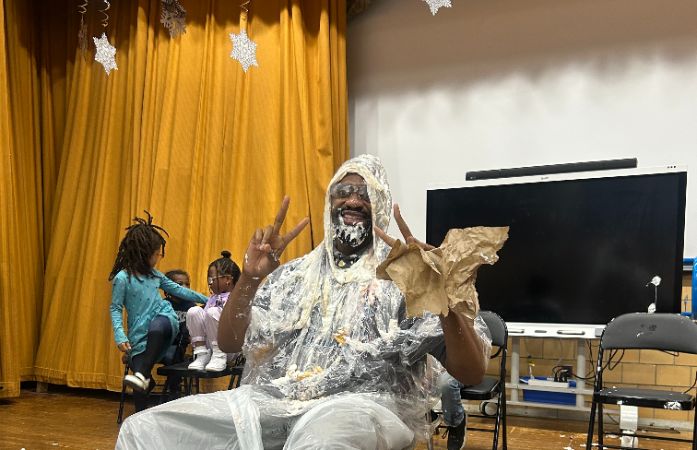  principal with pie on his face